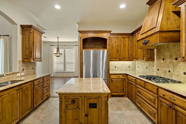 a kitchen with stainless steel appliances granite countertop a sink and cabinets