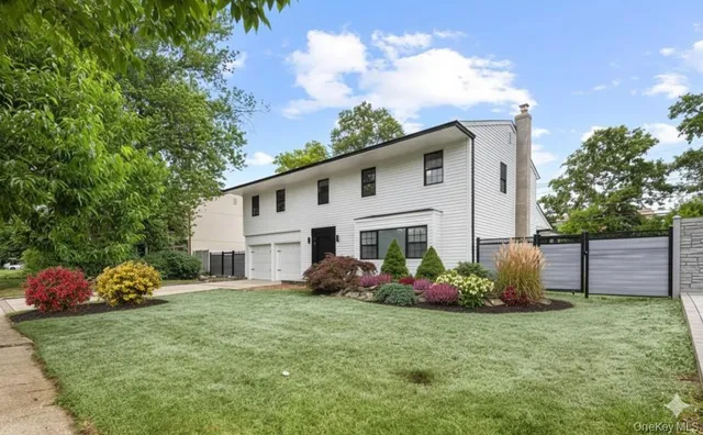 a front view of a house with a garden