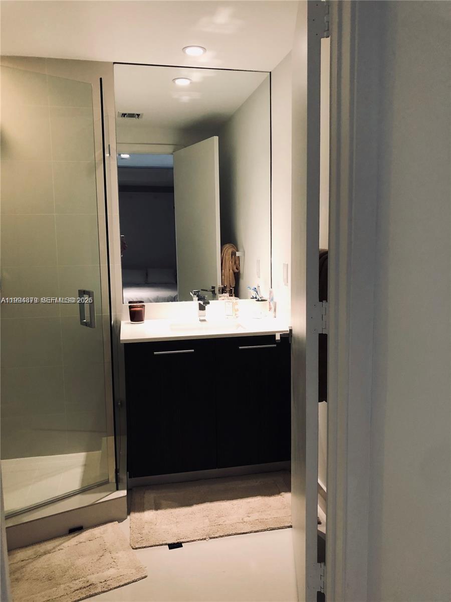 45 Southwest 9th Street, Unit 2004 Miami, FL 33130 - Photo 16 of 28 a bathroom with a sink and a mirror