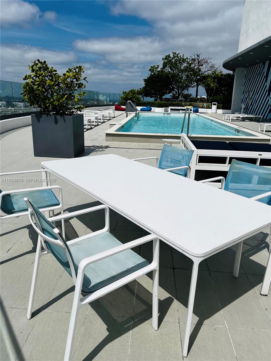 45 Southwest 9th Street, Unit 2004 Miami, FL 33130 - Photo 23 of 28 a terrace with outdoor seating and lots of potted plants
