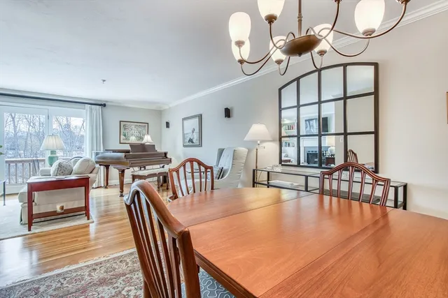 a view of a dining room with furniture and chandelier