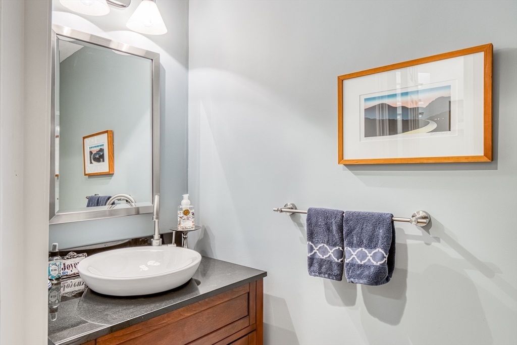 433 Main Street, Unit 4 Medfield, MA 02052 - Photo 17 of 36 a bathroom with a toilet sink and mirror