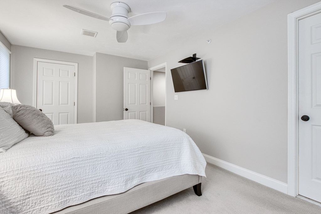 433 Main Street, Unit 4 Medfield, MA 02052 - Photo 24 of 36 a bedroom with a bed and tv