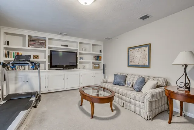 a bedroom with a bed a table and chair