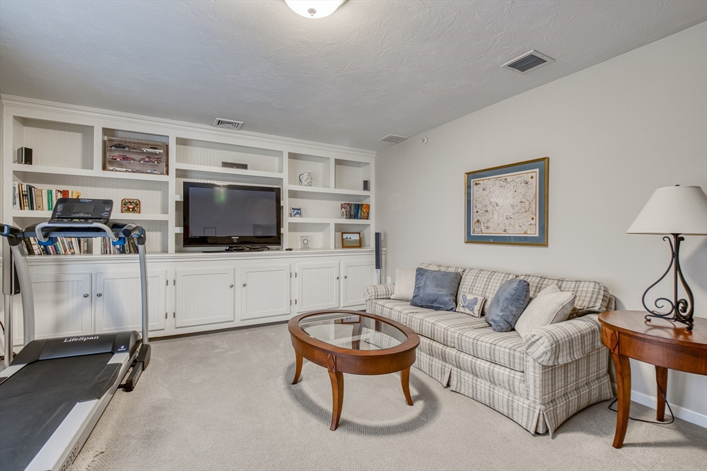 433 Main Street, Unit 4 Medfield, MA 02052 - Photo 27 of 36 a living room with furniture and a flat screen tv
