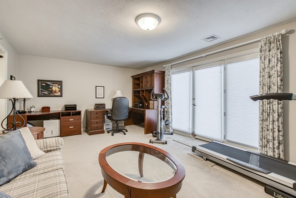 433 Main Street, Unit 4 Medfield, MA 02052 - Photo 28 of 36 a room with gym equipment and a large window