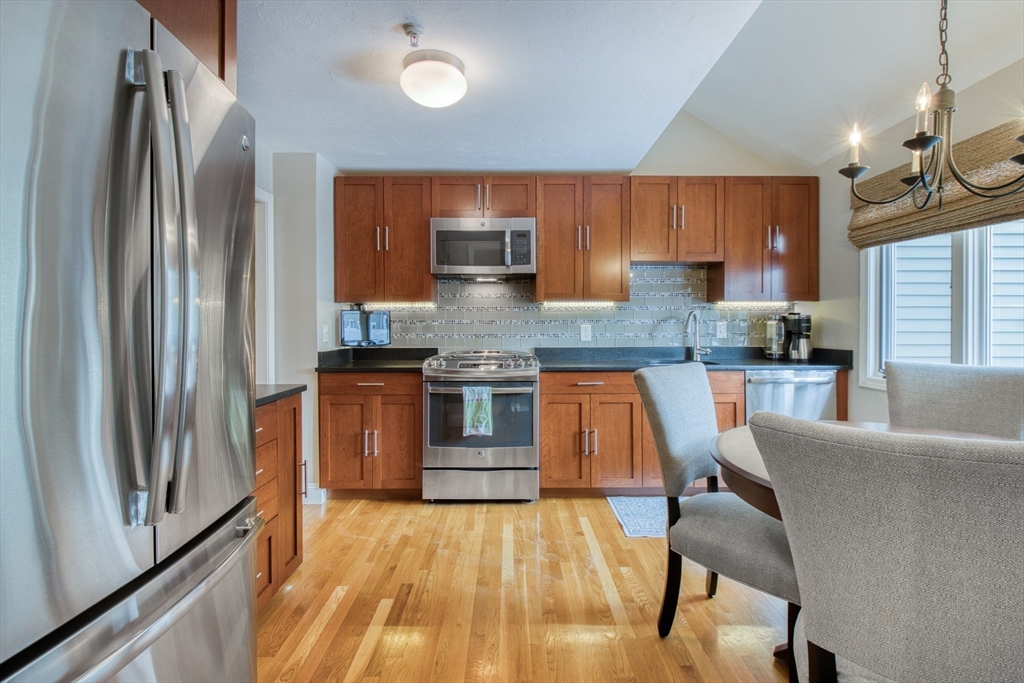433 Main Street, Unit 4 Medfield, MA 02052 - Photo 8 of 36 a kitchen with stainless steel appliances granite countertop a refrigerator a stove top oven a sink and dishwasher
