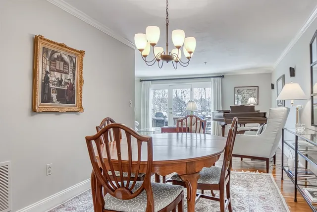 a view of a dining room with furniture and chandelier