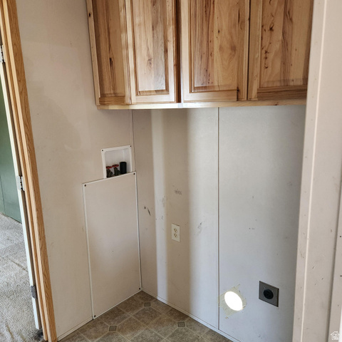 3760 Gold Ridge Drive, Unit 82 Magna, UT 84044 - Photo 17 of 29 Laundry space featuring wood-finish cabinetry, patterned linoleum flooring, and a washer/dryer hookup