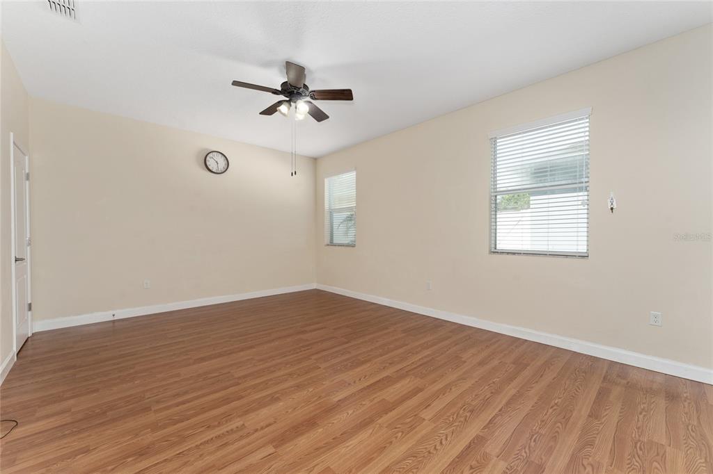 1355 Vasey Road Apopka, FL 32703 - Photo 22 of 41 an empty room with wooden floor fan and windows