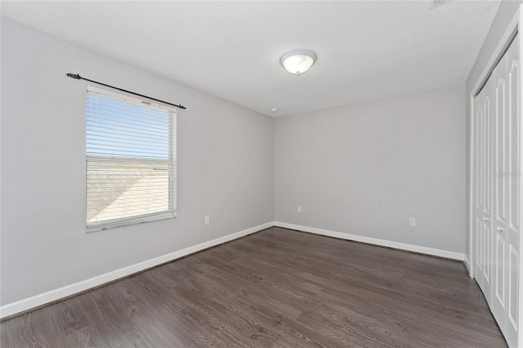 1355 Vasey Road Apopka, FL 32703 - Photo 29 of 41 an empty room with wooden floor and windows