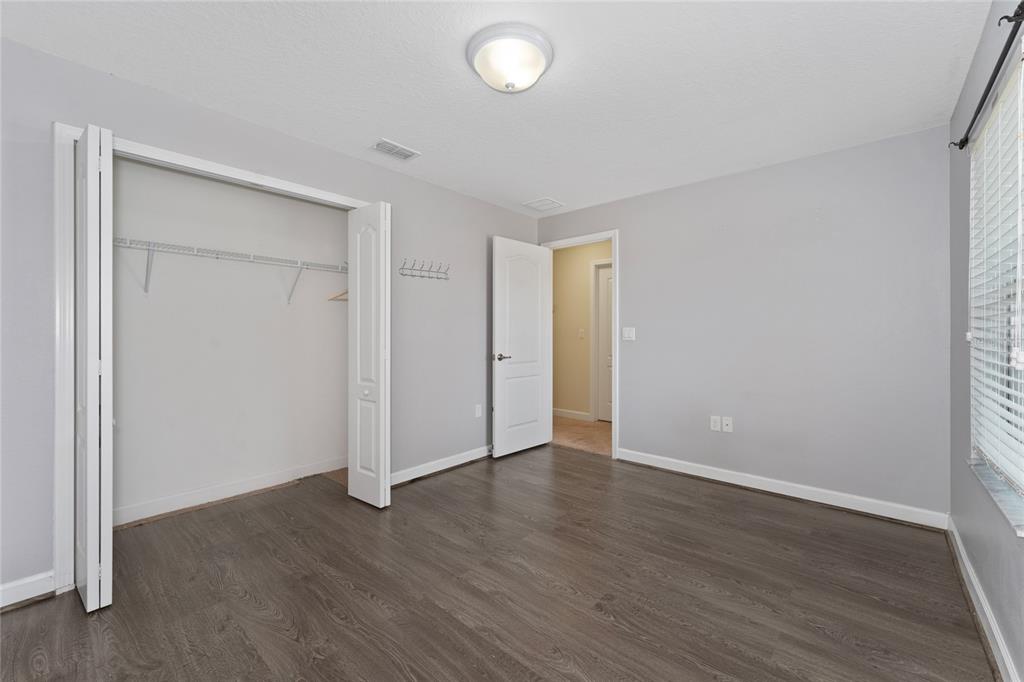 1355 Vasey Road Apopka, FL 32703 - Photo 30 of 41 an empty room with wooden floor and windows