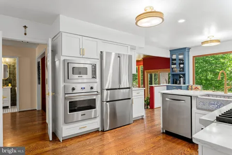a kitchen with stainless steel appliances a refrigerator stove and sink