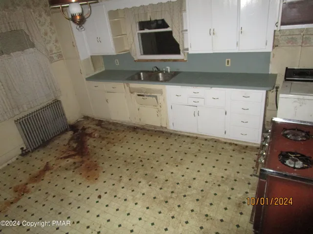a kitchen with granite countertop a sink and a stove