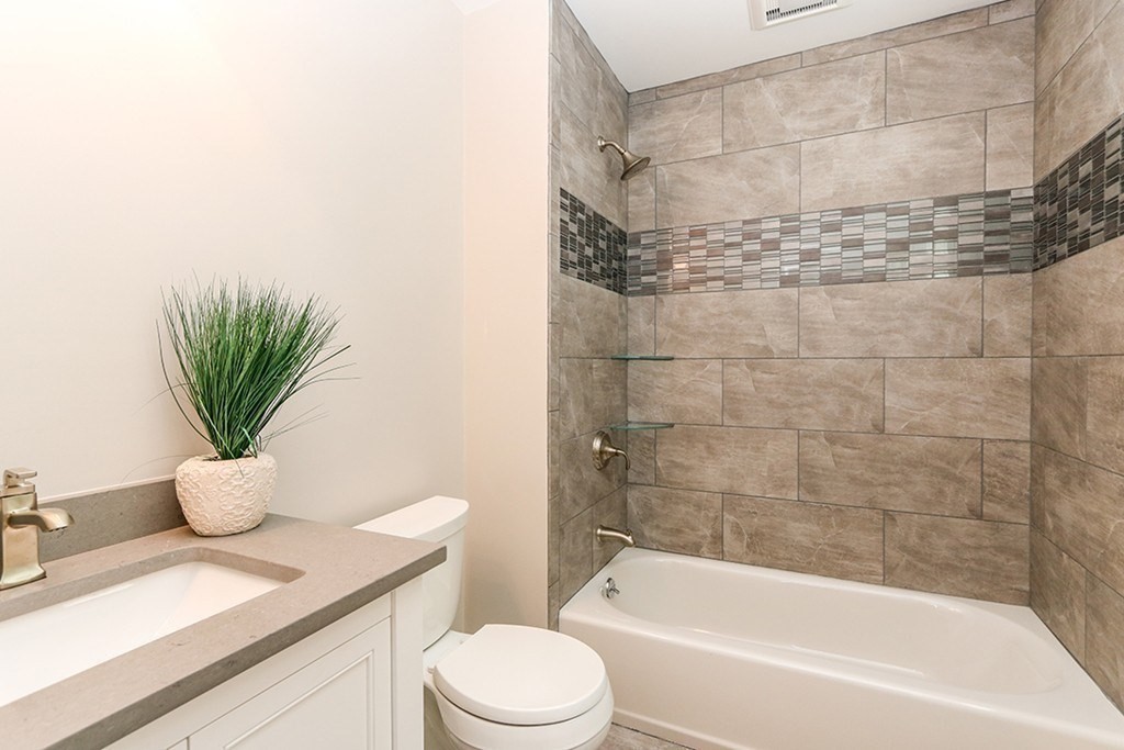 80 Sachem Road Needham, MA 02494 - Photo 21 of 26 a bathroom with a sink a toilet a mirror and shower