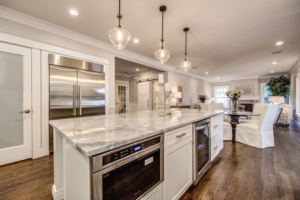 80 Sachem Road Needham, MA 02494 - Photo 7 of 26 a kitchen with stainless steel appliances granite countertop a stove and a wooden floor
