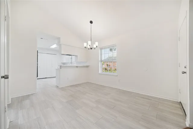 en empty room with windows and ceiling fan