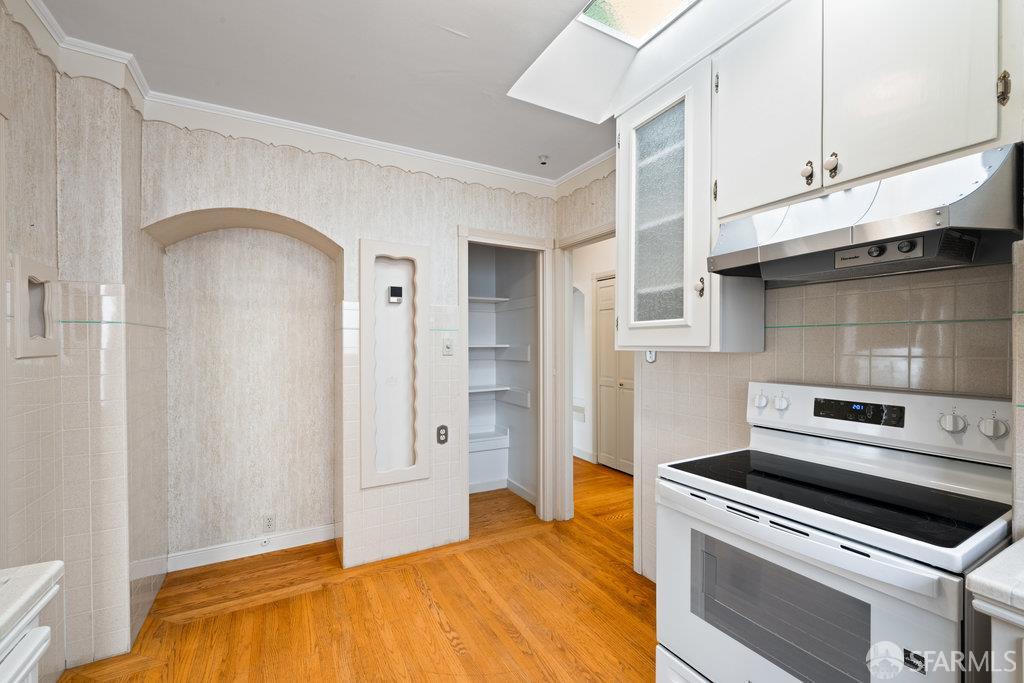1653 16th Avenue San Francisco, CA 94122 - Photo 16 of 33 a kitchen with a stove and a sink
