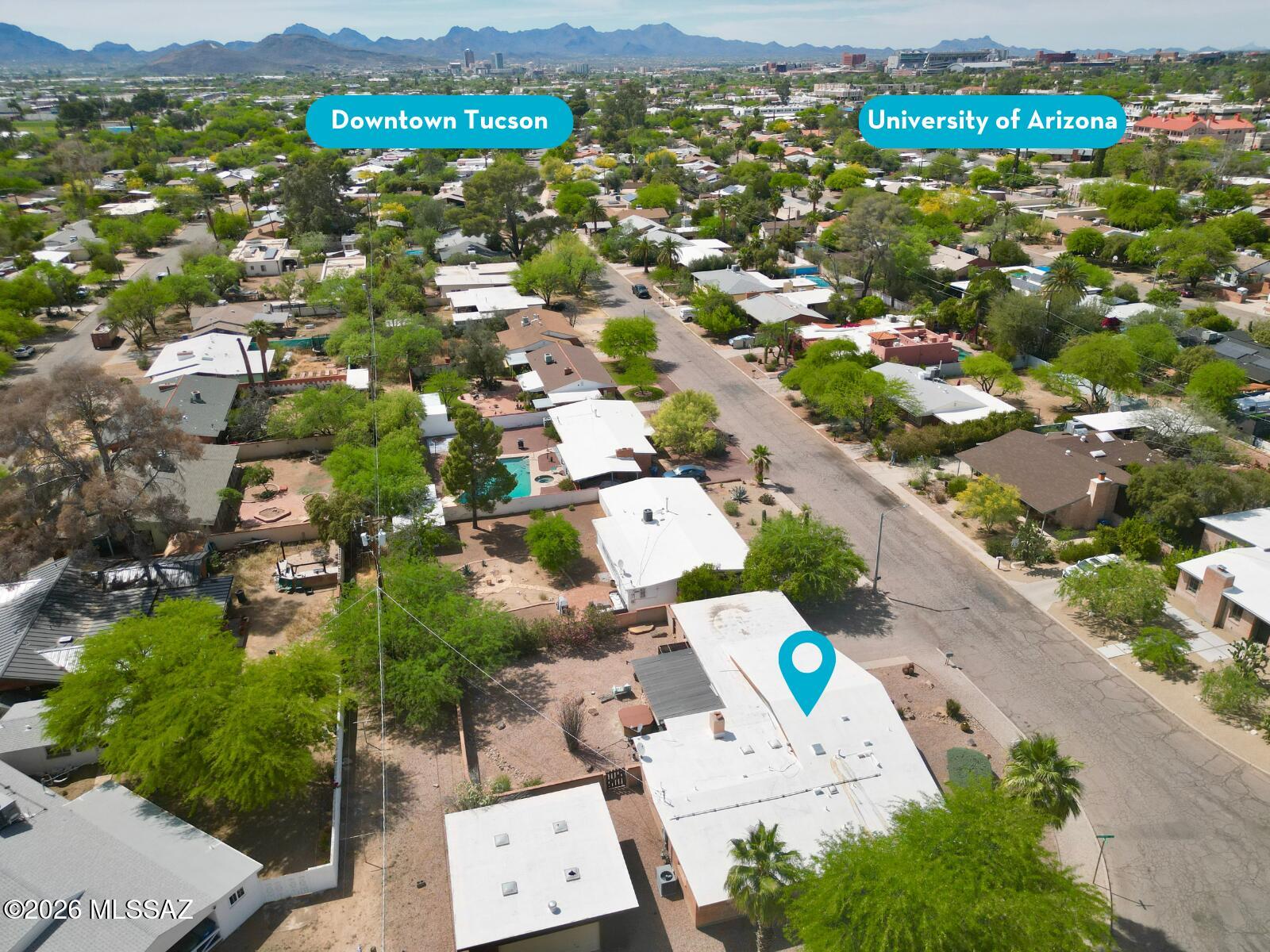 2934 East Exeter Street Tucson, AZ 85716 - Photo 2 of 20 an aerial view of a city with lots of residential buildings and mountain view in back