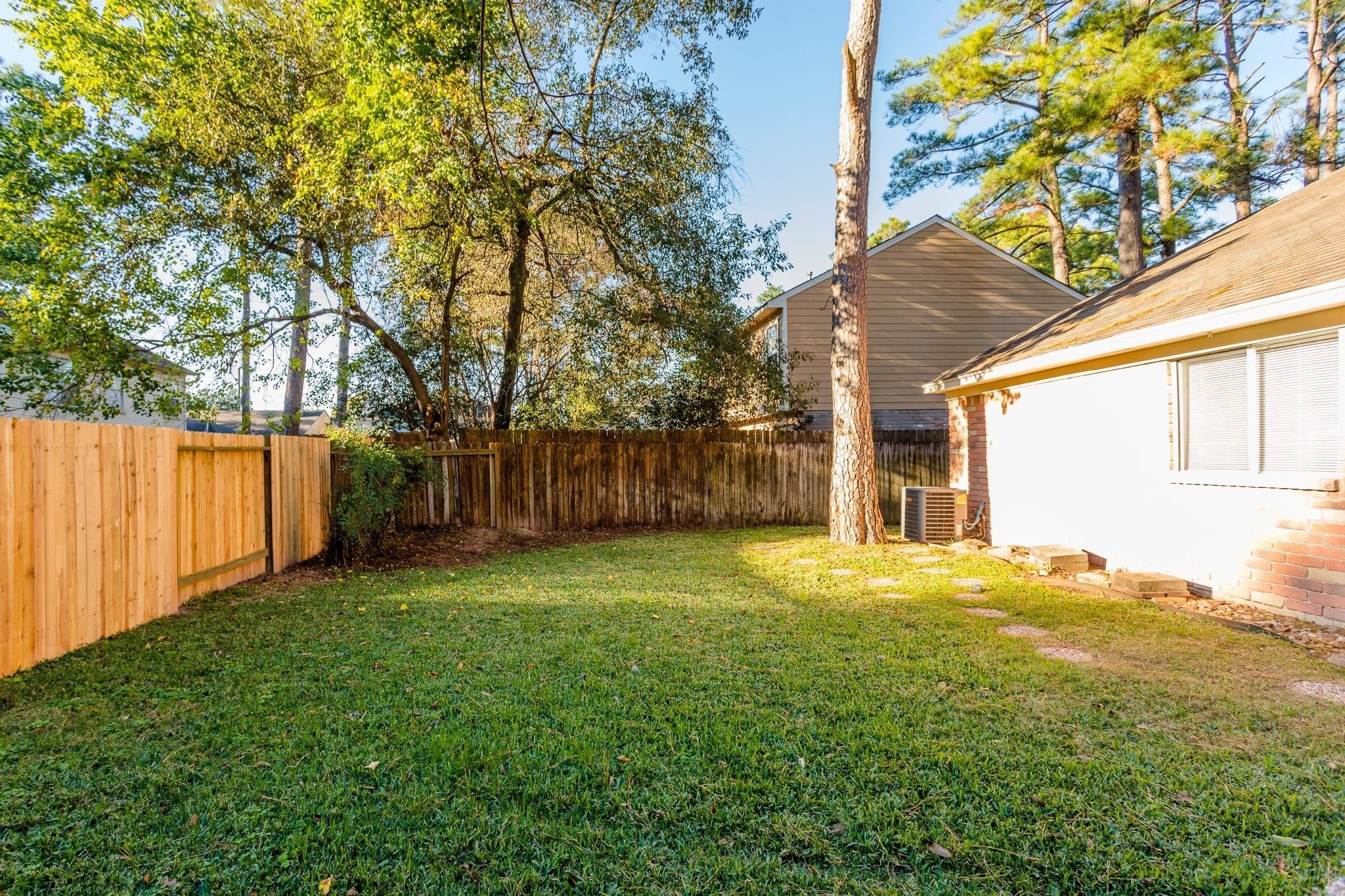 9206 Towerstone Drive Spring, TX 77379 - Photo 6 of 7 a view of a yard with a house and a large tree
