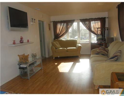 8 Roger Road Edison, NJ 08817 - Photo 2 of 10 a living room with furniture and a flat screen tv