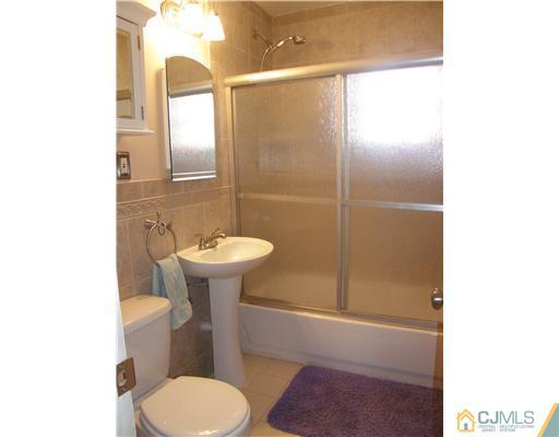 8 Roger Road Edison, NJ 08817 - Photo 3 of 10 a bathroom with a sink toilet and mirror