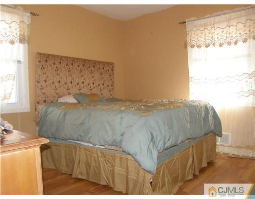 8 Roger Road Edison, NJ 08817 - Photo 4 of 10 a bedroom with a bed and a window