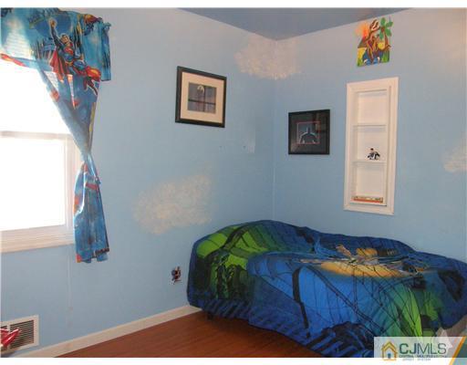 8 Roger Road Edison, NJ 08817 - Photo 6 of 10 a bedroom with a bed and a painting on the wall