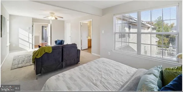 a bedroom with a bed and windows