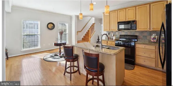 a kitchen with appliances cabinets and a table