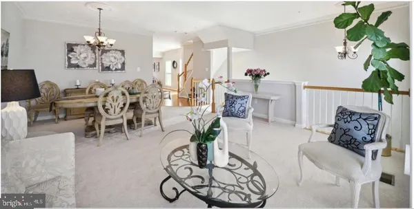 a living room with furniture a chandelier and a chandelier