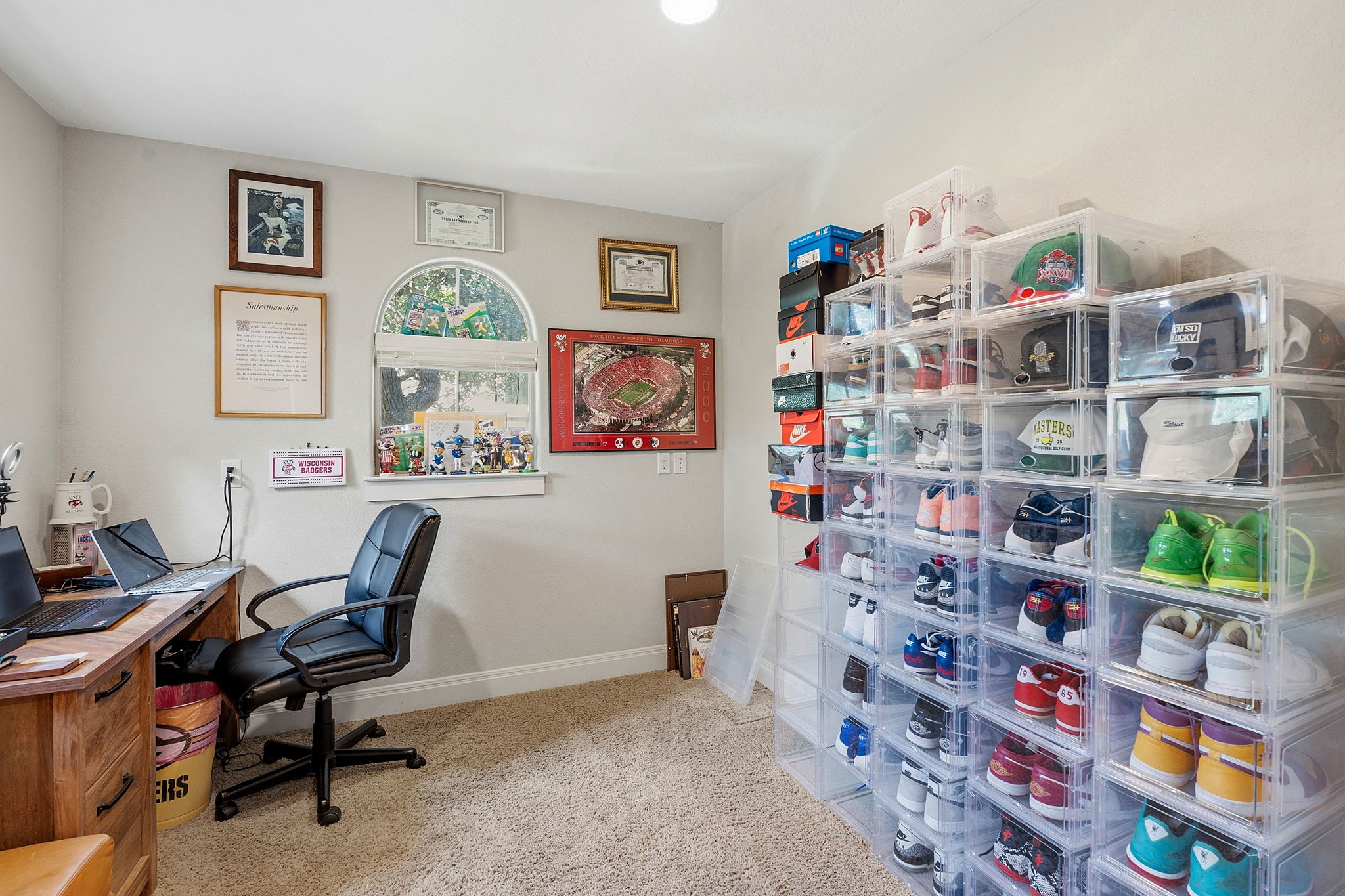 15317 Falconhead Grove Loop Austin, TX 78738 - Photo 21 of 36 Dedicated room featuring a warm beige carpet, a decorative arched window, light neutral wall paint, and a built-in wooden desk with drawers