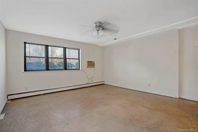 an empty room with a empty space and windows