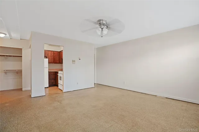 a view of an empty room with closet