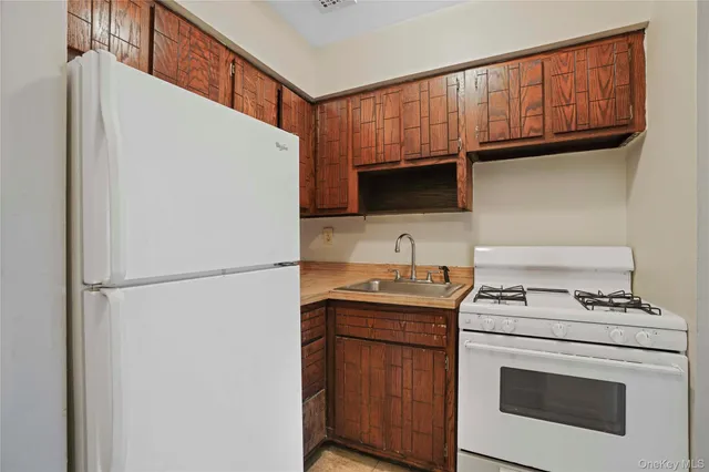 a kitchen with appliances a sink and cabinets