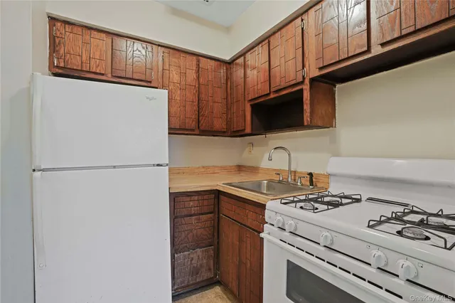 a kitchen with stainless steel appliances granite countertop a stove a refrigerator and a sink