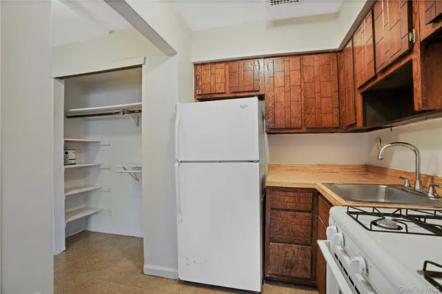 a kitchen with a refrigerator stove and a sink