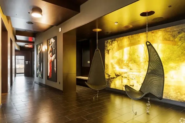 a kitchen with stainless steel appliances kitchen island granite countertop a table chairs and a refrigerator