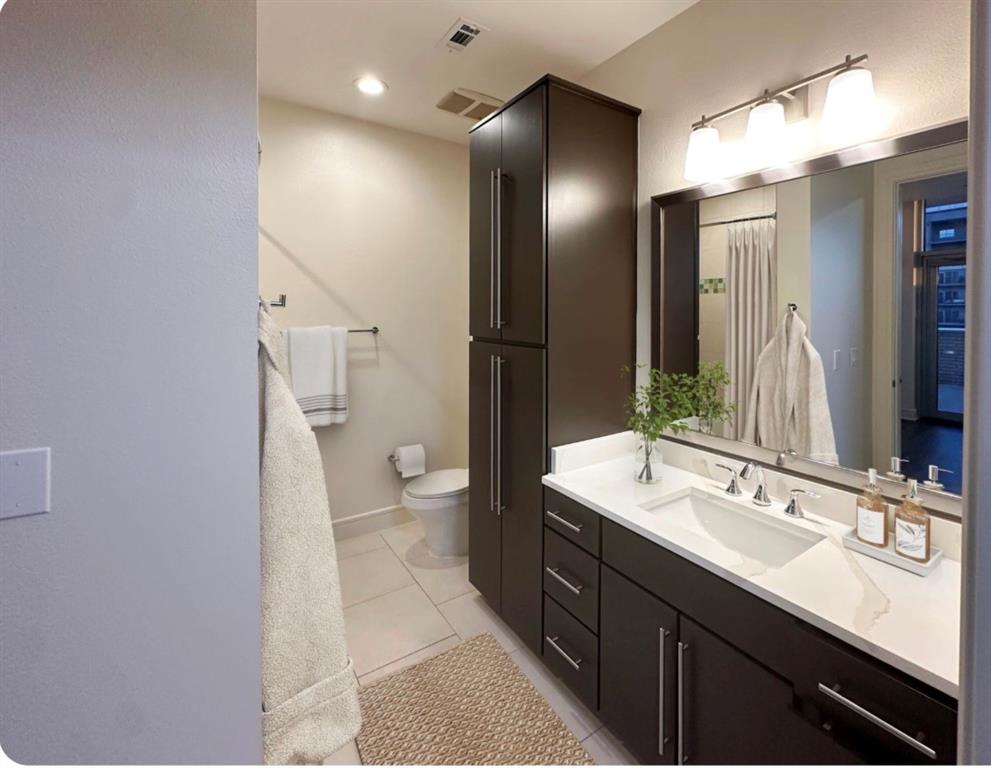 1700 Cedar Springs Road, Unit 2508 Dallas, TX 75201 - Photo 3 of 40 a bathroom with a double vanity sink mirror and toilet