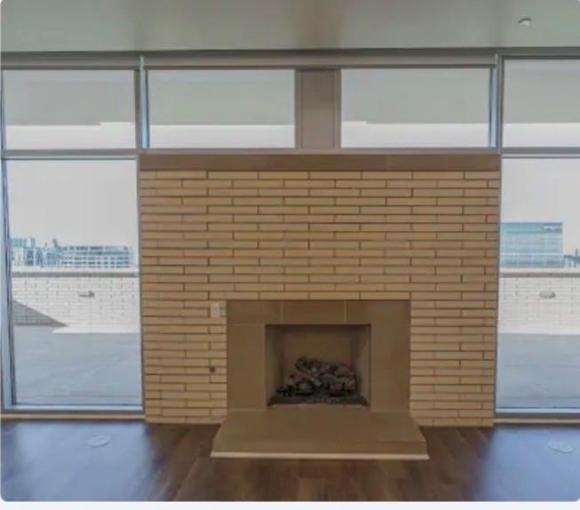 1700 Cedar Springs Road, Unit 2508 Dallas, TX 75201 - Photo 31 of 40 Detailed view of a fireplace with raised hearth and wood finished floors