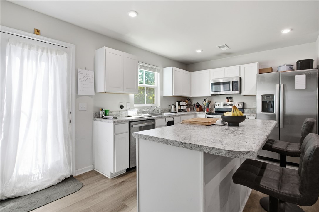 112 Wls Sta Road Seneca, SC 29678 - Photo 12 of 42 Sleek laminate counter-tops and a central island ground this contemporary kitchen space.