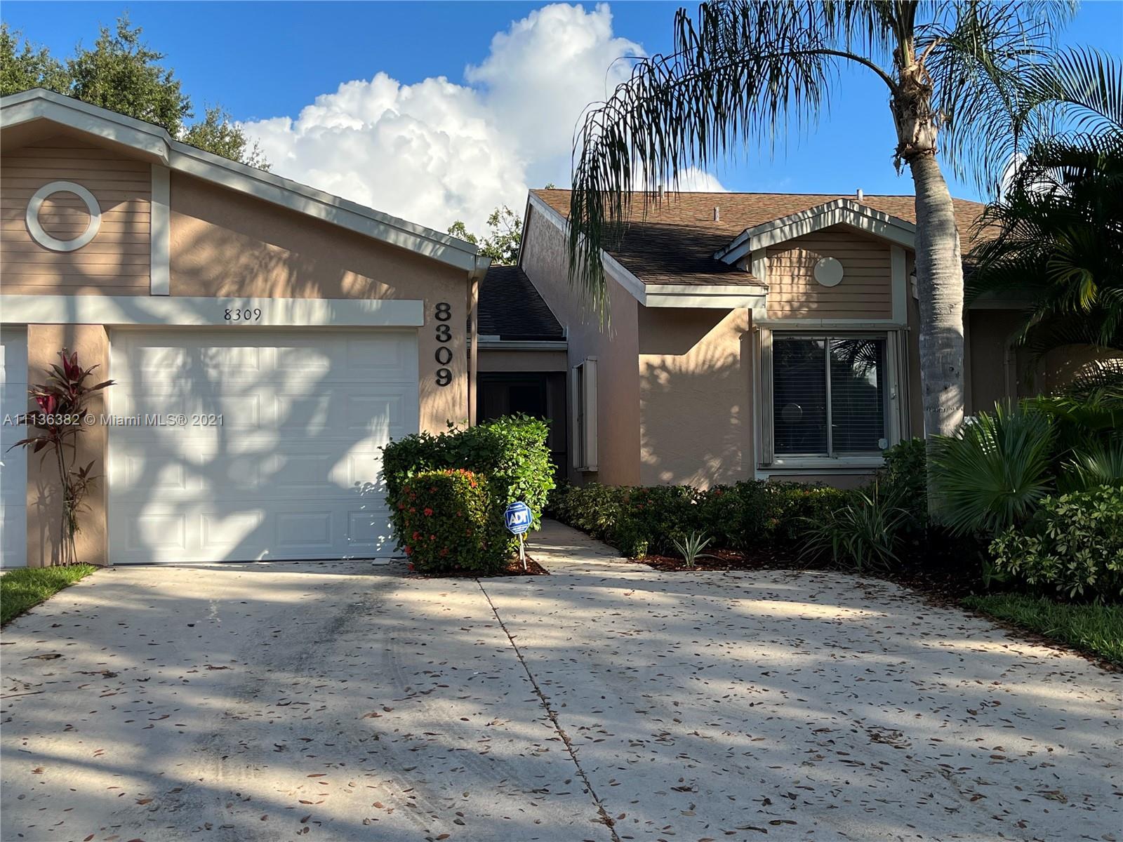 8309 Springtree Road, Unit 8309 Boca Raton, FL 33496 - Photo 1 of 18 a view of a house with a yard