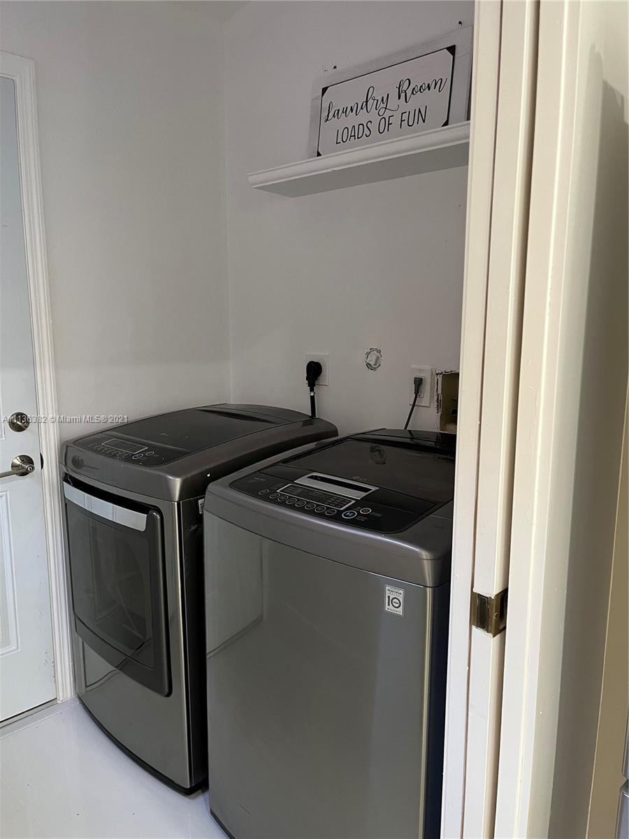 8309 Springtree Road, Unit 8309 Boca Raton, FL 33496 - Photo 7 of 18 a utility room with dryer and washer