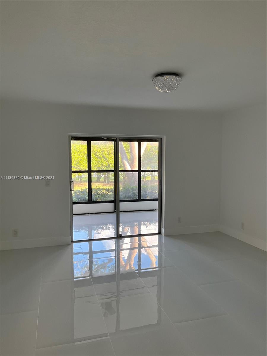 8309 Springtree Road, Unit 8309 Boca Raton, FL 33496 - Photo 10 of 18 a view of an empty room with a window