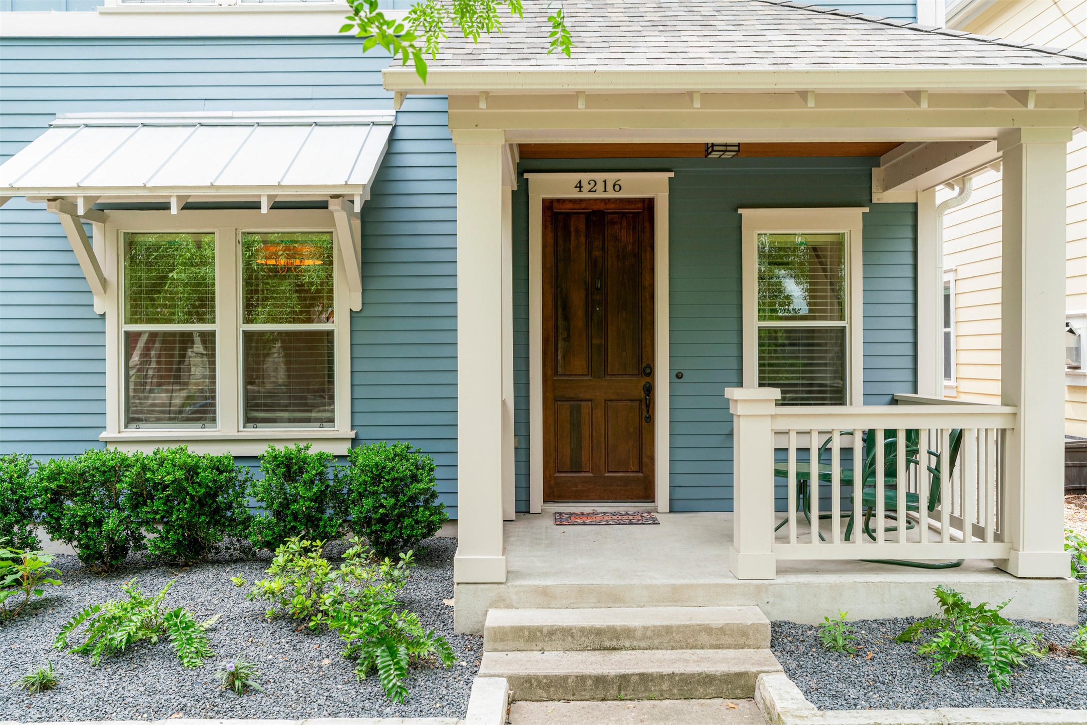 4216 Threadgill Street Austin, TX 78723 - Photo 11 of 40 a front view of a house with large windows and plants