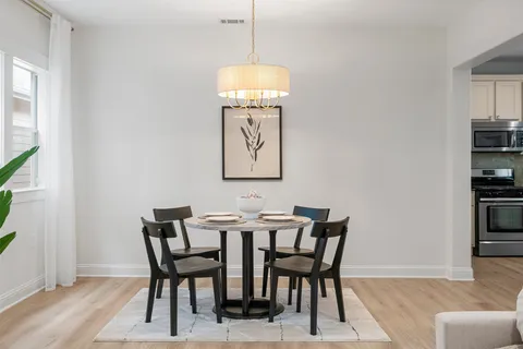 a dining room with furniture and window
