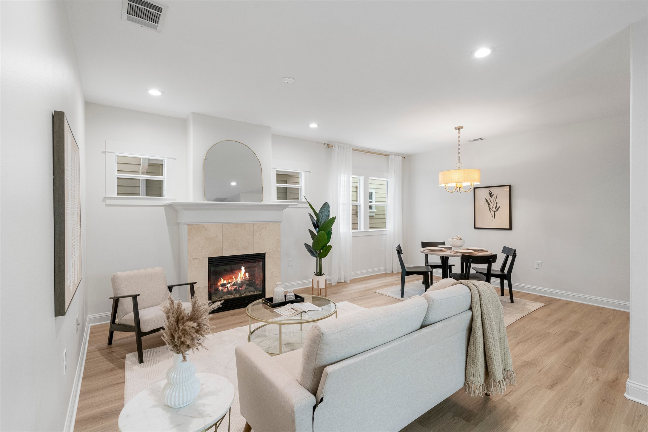 4216 Threadgill Street Austin, TX 78723 - Photo 2 of 40 a living room with furniture a fireplace and a wooden floor