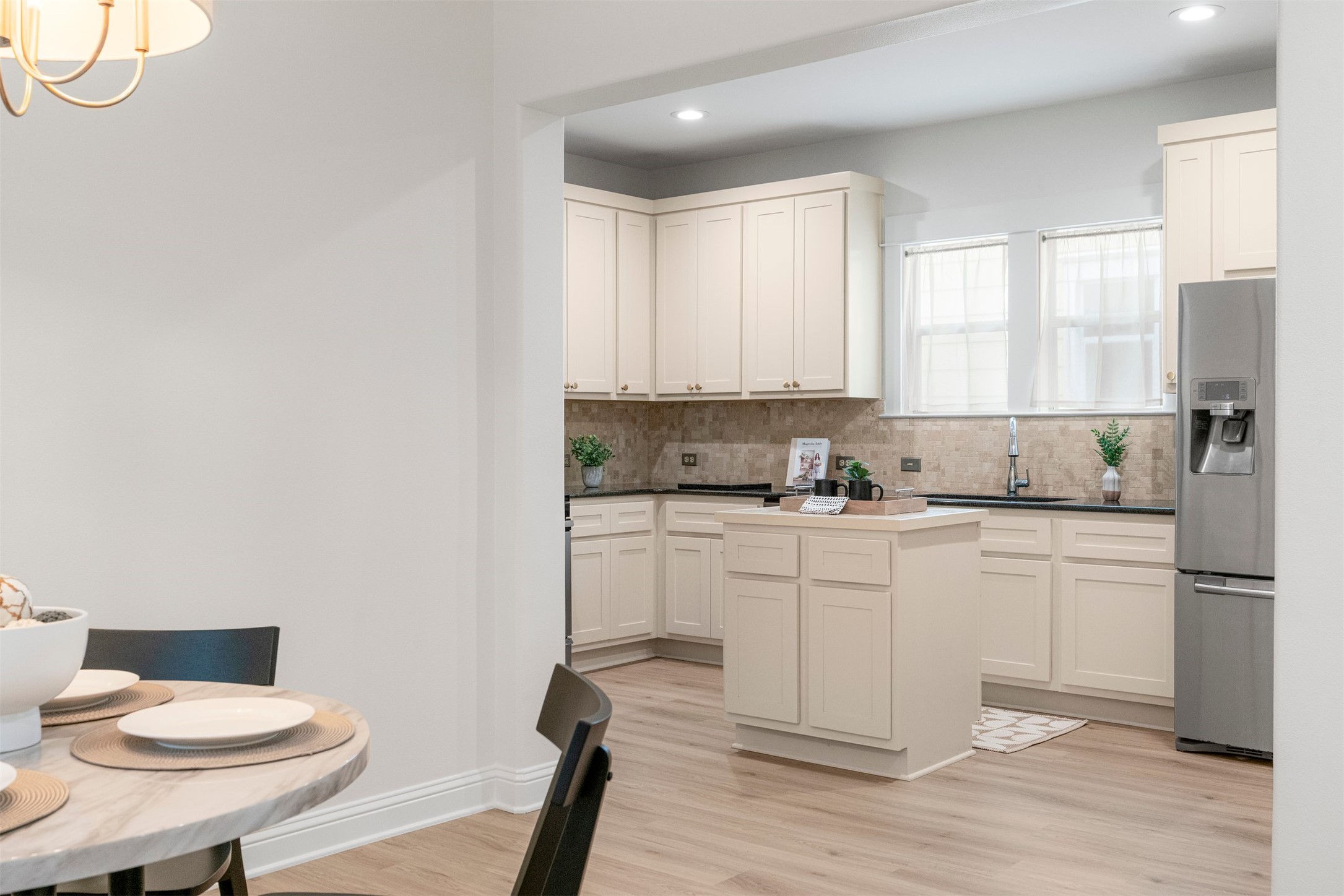 4216 Threadgill Street Austin, TX 78723 - Photo 21 of 40 a kitchen with stainless steel appliances white cabinets and wooden floor