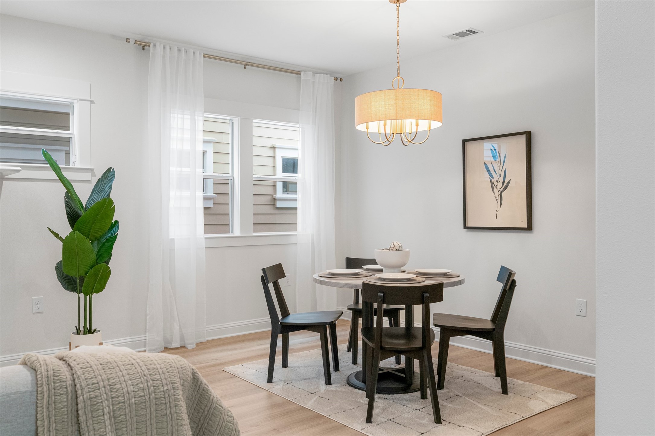 4216 Threadgill Street Austin, TX 78723 - Photo 3 of 40 a dining room with furniture and a chandelier
