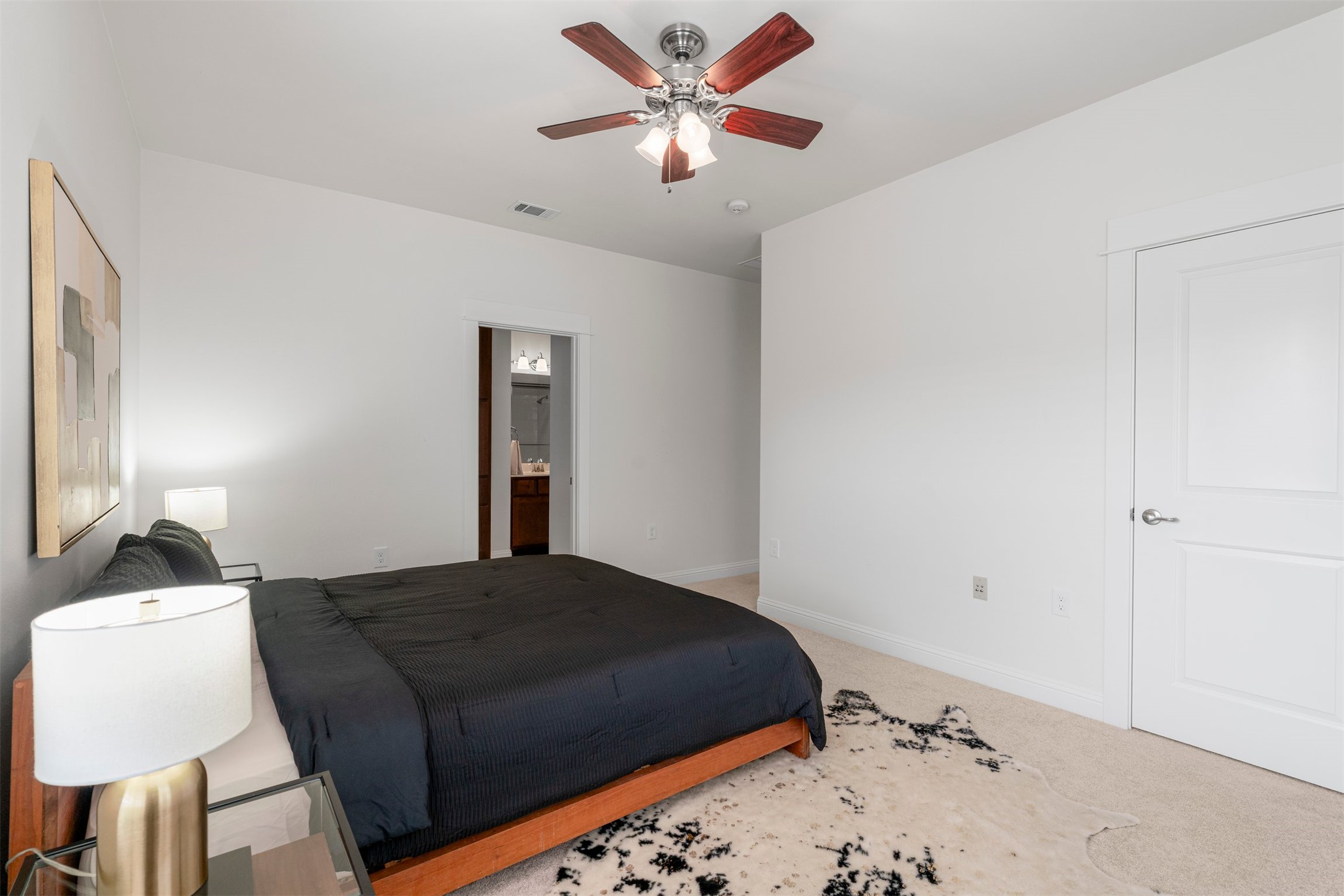 4216 Threadgill Street Austin, TX 78723 - Photo 33 of 40 a bedroom with a bed and a lamp on the dresser